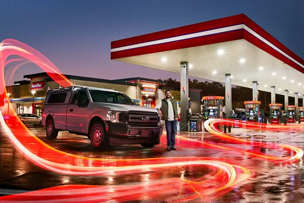 Fleet driver in front of a pickup truck at a RaceTrac gas station