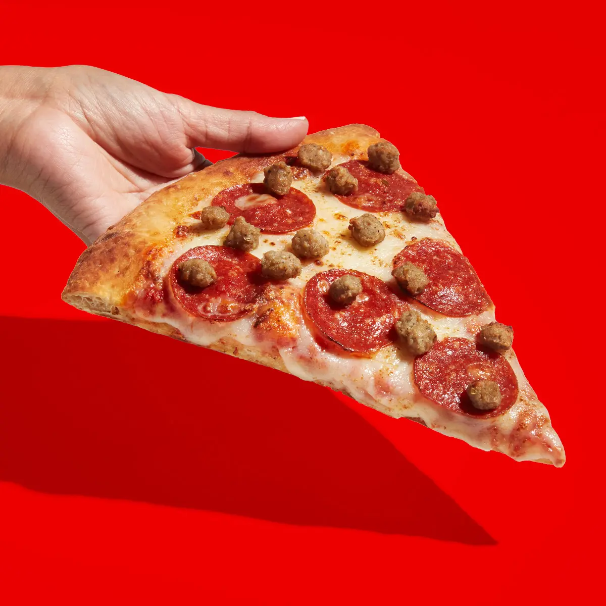 Slice of sausage and pepperoni pizza