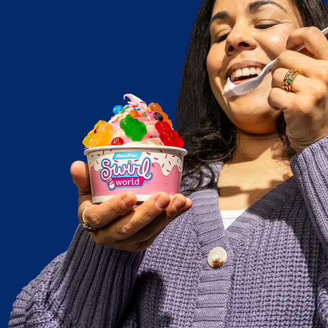 Woman eating a Swirl World frozen yogurt